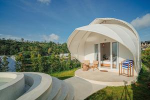 a circular house with a dome roof with a patio at Onion Hill Glamping by Manara in Kintamani
