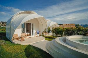 a large dome shaped house with a swimming pool at Onion Hill Glamping by Manara in Kintamani