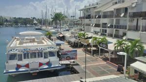 a boat docked in a marina next to buildings at Joli Studio Vue Sur Mer in Pointe-à-Pitre +6 photos