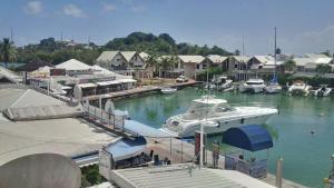 a boat is docked in a marina with houses at Joli Studio Vue Sur Mer in Pointe-à-Pitre