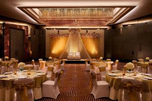 a banquet hall with tables and chairs and a stage at JW Marriott Hotel Chandigarh in Chandīgarh +54 photos