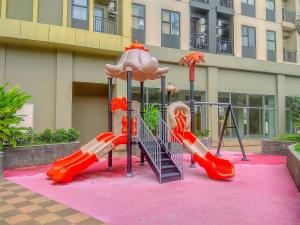 a playground with a slide at Great Location and Comfy 2BR Transpark Cibubur Apartment By Travelio in Depok