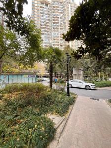 um carro branco está estacionado em uma rua com prédios em Sunny Abode 中远A 2Bedroom river view near Suzhou River em Xangai