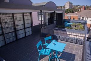 a patio with two chairs and a table on a building at Savoy Double Bay Hotel in Sydney