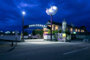 松本Hotel TEMARI Matsumoto的夜间建筑物前的街道灯