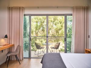 a bedroom with a bed and a balcony with a table and chairs at Maya Maya at Mandoon Estate in West Swan +49 photos