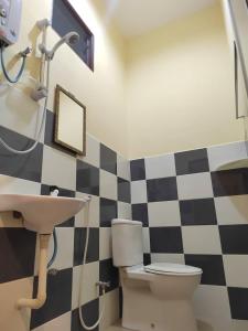 a bathroom with a toilet and a sink at Four F Motel by Lily in Pantai Cenang