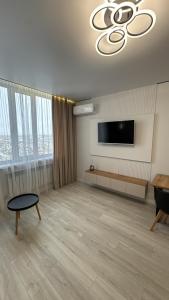 a living room with a flat screen tv on a wall at АК Апартамент in Kirovo +25 photos