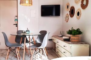 a dining room with a table and chairs and a tv at Departamento Arístides Origen y Encanto en Mendoza in Mendoza +32 photos