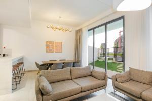 a living room with a couch and a table at RAKvista Residence in Ras al Khaimah