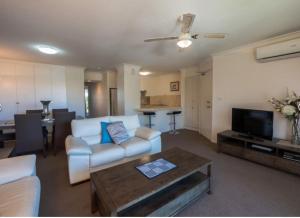 a living room with a couch and a table at Bayview Waters Apartments in Gold Coast