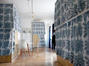 a room with blue and white wallpaper and a table and chairs at Follow the Sun Boutique Hostel - Pool, Breakfast & Sea Views in St. Julianʼs