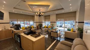 a lobby with couches and chairs in a building at Uptown Hotel Apartments Abu Dhabi by Gewan in Abu Dhabi