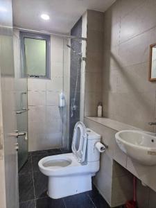 a bathroom with a toilet and a sink at D'Loft 7 Homestay in Kota Kinabalu