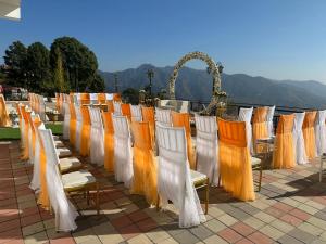 a row of chairs with orange and white at Peaks And Pines Resort in Lansdowne