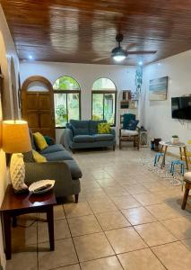 a living room with two couches and a table at La Buena Vida 2 in Tamarindo