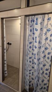 a glass door with a shower curtain in a bathroom at Zimmer A in Mönchengladbach