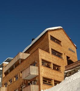 a brick building with snow in front of it at Abitare in Obergurgl