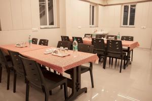 a row of tables and chairs in a room at Sky Stay Resorts in Yercaud