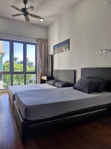 a bedroom with a large bed with a ceiling fan at D'Loft 7 Homestay in Kota Kinabalu