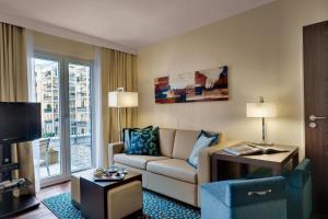a living room with a couch and a tv at Residence Inn by Marriott Munich City East in Munich