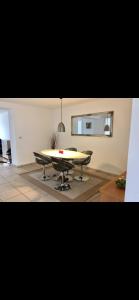 a dining room with a table and two chairs at Modern & Spacious apartment in Silkeborg