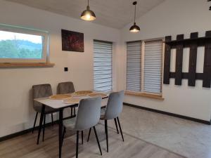 a dining room with a table and chairs at Family House Volosianka in Volosyanka