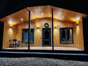 a wooden building with a table and a door at Family House Volosianka in Volosyanka