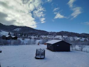a tent sitting in the snow next to a building at Family House Volosianka in Volosyanka