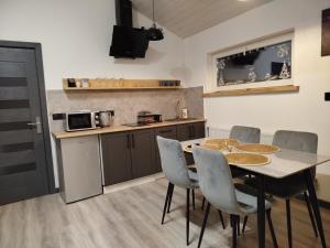 a kitchen with a table and chairs in a room at Family House Volosianka in Volosyanka