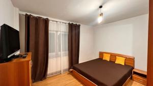 Μια τηλεόραση ή/και κέντρο ψυχαγωγίας στο City Central Apartment - Craiova