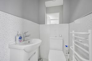 a white bathroom with a sink and a toilet at Studio 169 in London +34 photos