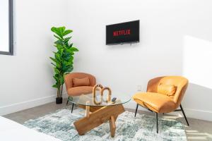 a living room with two chairs and a glass table at Urban Oasis in Miami Close to Bayside and Brickell with Free Parking in Miami