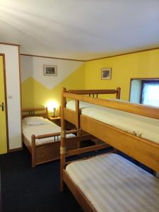 a room with three bunk beds and a window at Gîte de la Peyrouse in Saint-Jean-de-Vaux