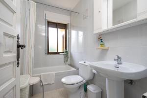 a white bathroom with a toilet and a sink at Appto Turístico La Franca LFRA002R in La Franca