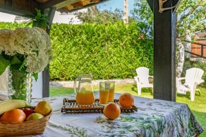 a table with fruit and two glasses of orange juice at Appto Turístico La Franca LFRA002R in La Franca +16 photos
