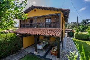 an exterior view of a house with a roof at Appto Turístico La Franca LFRA002R in La Franca