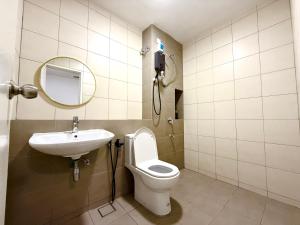 a bathroom with a sink and a toilet and a mirror at Alura Cove Bandar Bukit Raja, Setia Alam in Klang