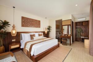 a bedroom with a large bed and a bathroom at Khastana Hadi Tegallalang, Ubud in Tegalalang