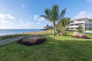 a view of the beach and a building at Riva Sagara by IHR in Flic-en-Flac