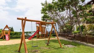 a playground in a park with a swing at Bratanov Garden of Eden in Sveti Vlas