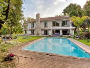 an estate with a swimming pool in front of a house at Bonne Chance Luxury Estate in Lynedoch