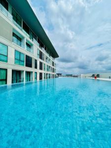 クチンにあるCozyDeLofts 2R2B near galacity, 5pax YPM1306の建物の前の大きなプール