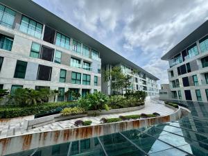 クチンにあるCozyDeLofts 2R2B near galacity, 5pax YPM1306のアパートメントの建物の正面にプールがあります。