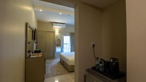 a hotel room with a bed and a hallway at Al Iqbal Hotel in Al Khobar