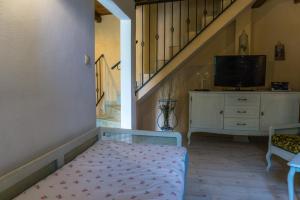 Zimmer mit einem Bett, einem TV und einer Treppe in der Unterkunft Casa Angeli in Banjol - Haus für 4-5 Personen in Rab