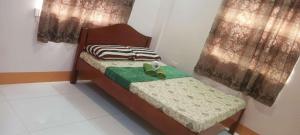 Un pat sau paturi într-o cameră la Room in BB - Aremen Transient, Nipa Hut