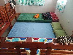 Un pat sau paturi într-o cameră la Room in BB - Aremen Transient, Nipa Hut