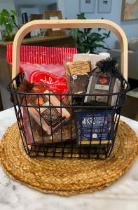 a basket filled with food on a table at Whitewash Beachfront Apartment on The Esplanade in Torquay