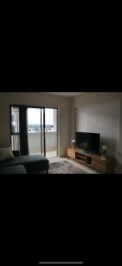a living room with a couch and a flat screen tv at Ballito bliss 2 in Ballito